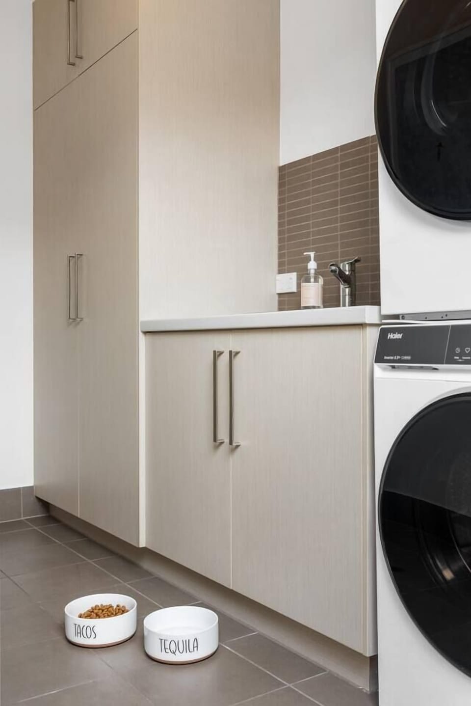 A private laundry with a washer, dryer and practical storage keeps beach towels, holiday outfits and longer stays feeling comfortable and convenient.