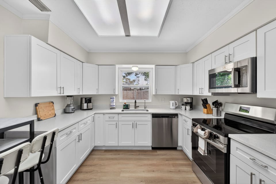 Spacious kitchen with abundant natural light, fully equipped.
