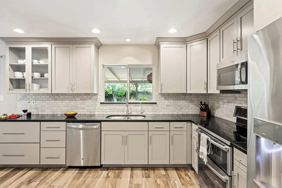 Fully equipped kitchen with stainless steal appliances, ample counter space, and a large pantry with a mini fridge and wine cooler.