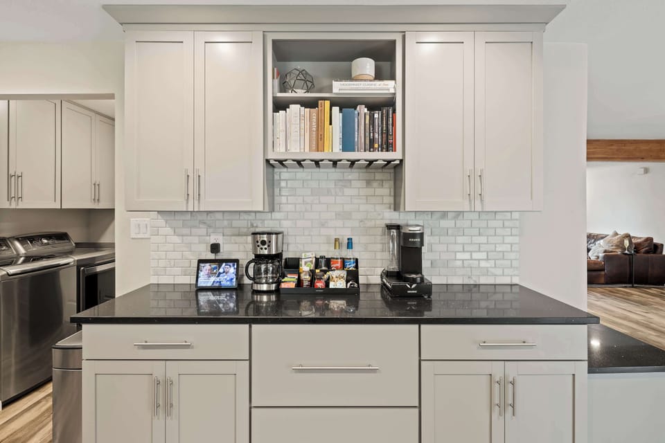 Fully equipped kitchen with stainless steal appliances, ample counter space, and a large pantry with a mini fridge and wine cooler.