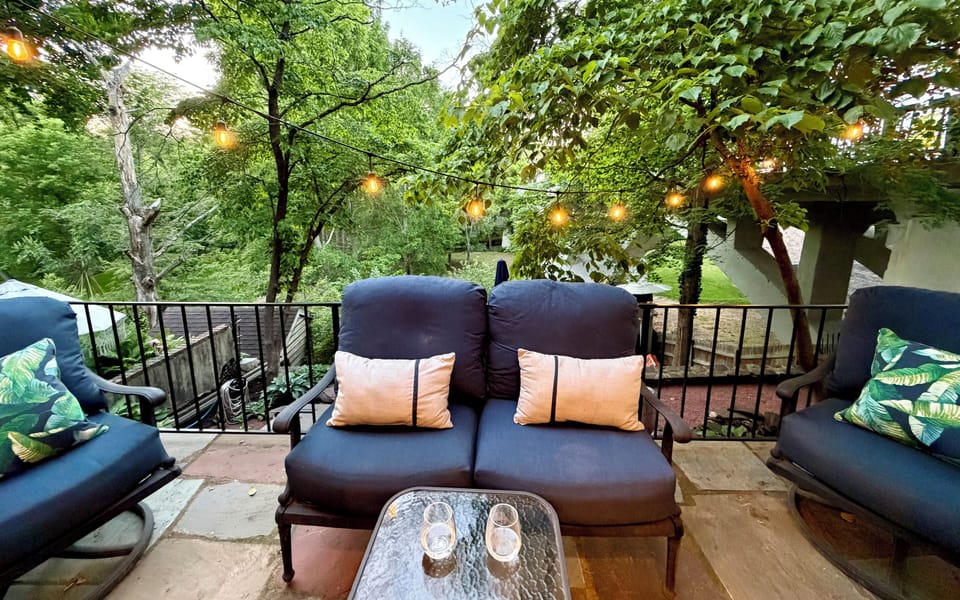 Outdoor - Deck with loveseat and 2 swivel chairs overlooking the Aquetong Creek.