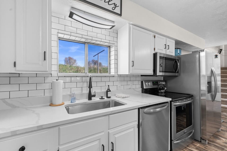 Kitchen | White Cabinetry & Granite Counters | Stainless Appliances