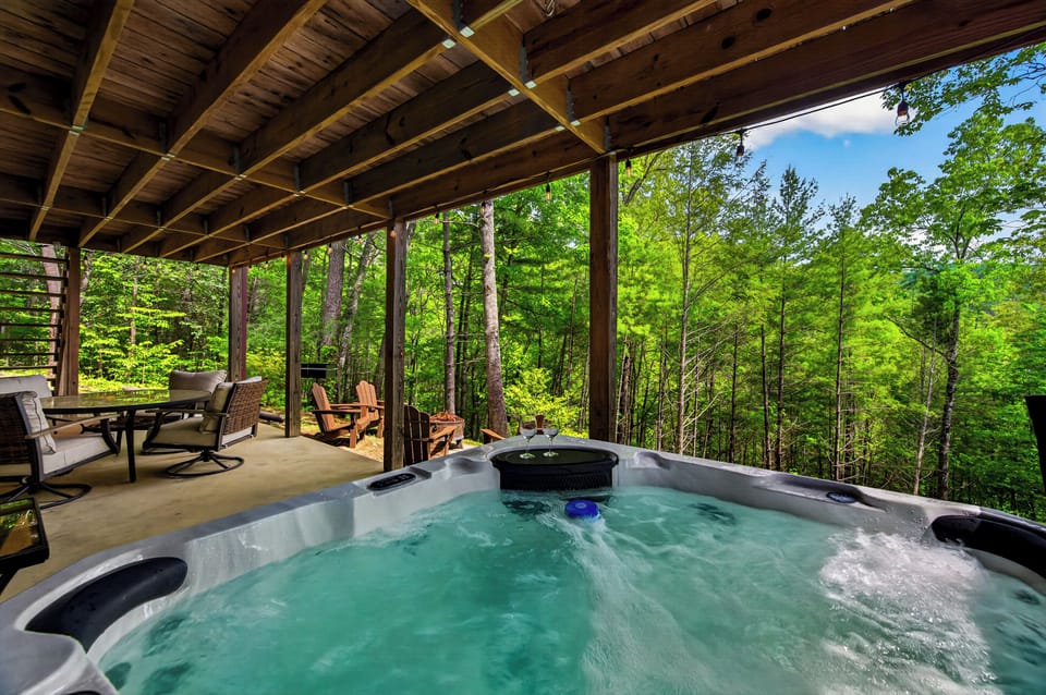 Soak in the hot tub with nothing but trees around you