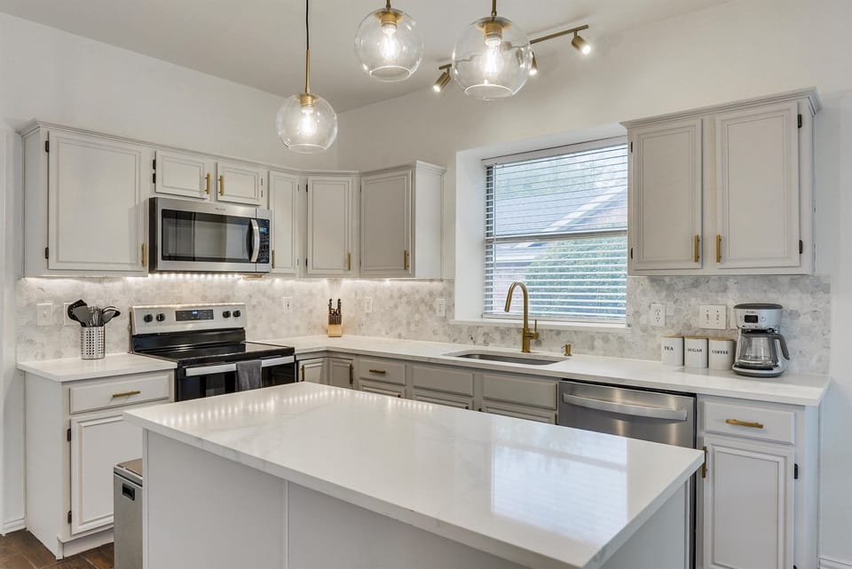 A sleek, contemporary kitchen featuring elegant finishes and an open feel, perfect for both everyday living and hosting guests.