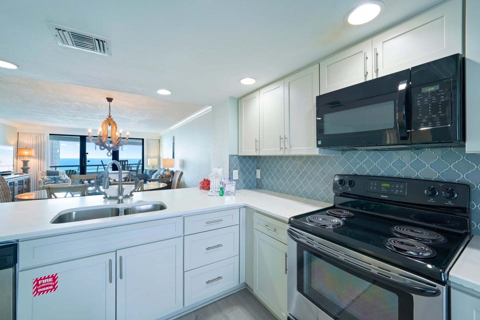 This updated kitchen includes all stainless steel appliances and quartz countertops with a stunning backsplash.
