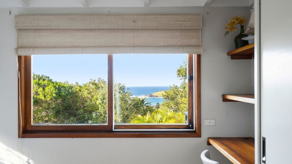 Expansive windows framing beautiful natural light and scenic views.