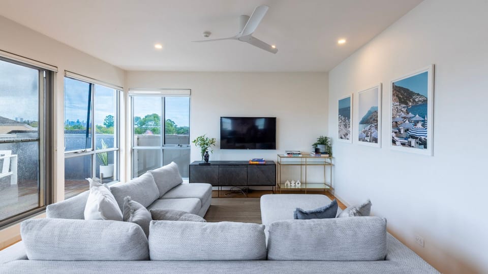 Large windows and sliding doors for natural light in the living room. 