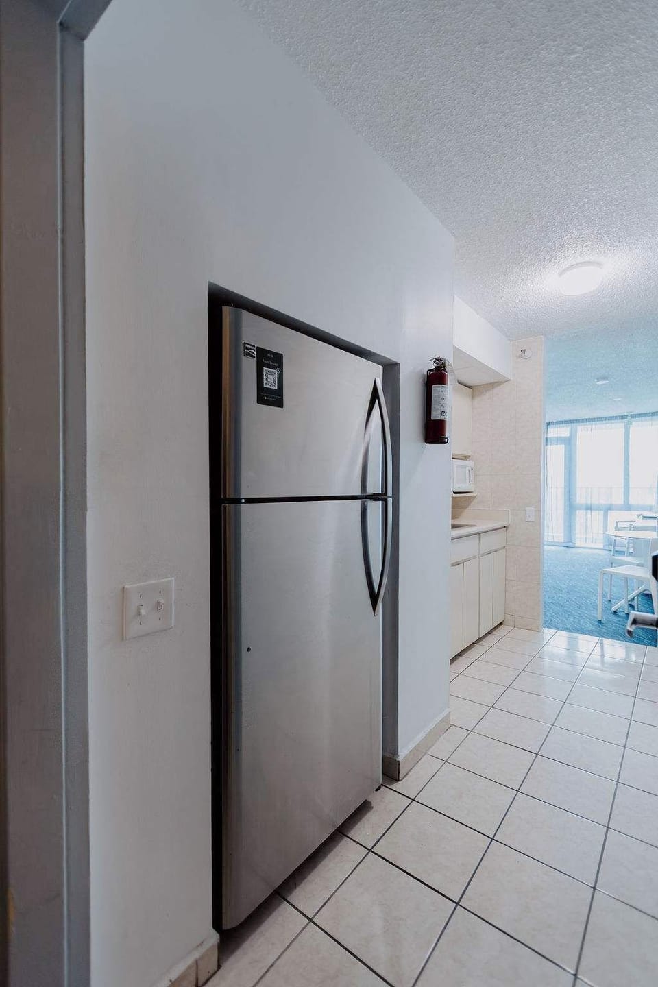 Stainless steel refrigerator near Isla Verde condo entrance, offering plenty of space for groceries during longer stays.