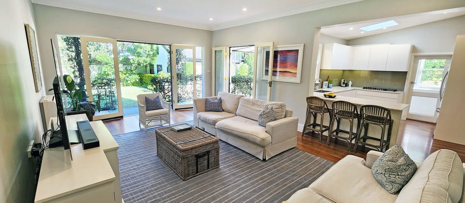 Living room with heating/cooling, TV. Leads out to large backyard.