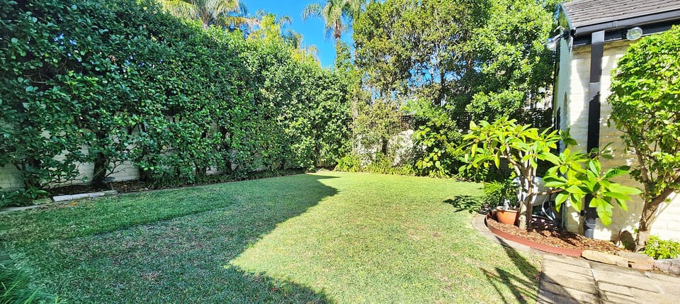 Sizeable private backyard with basketball hoop