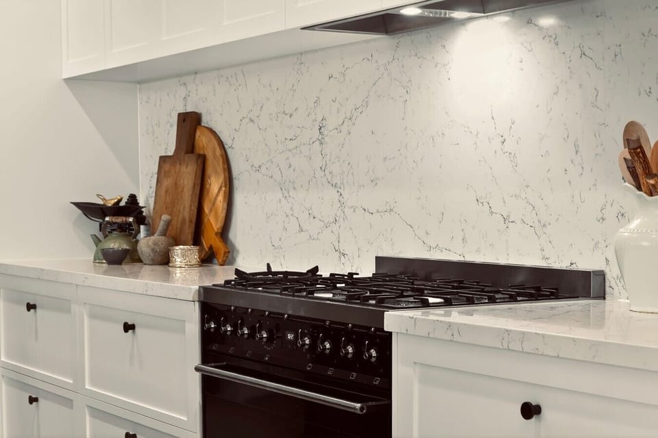 Designer kitchen featuring stone benchtops and quality appliances.