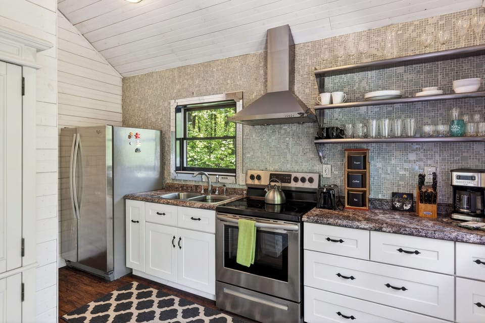 Sleek countertops and a decorative backsplash make meal prep a breeze.