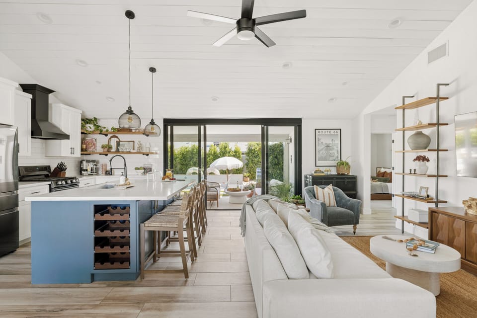 Open concept with sliding glass doors leading to the backyard oasis