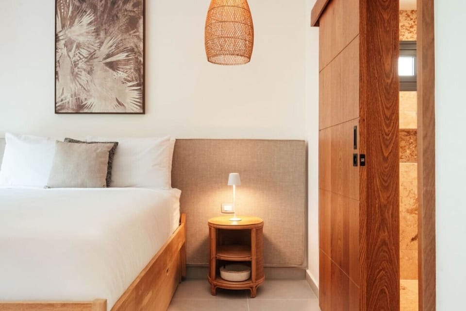 Bedroom 2 with a comfortable king-size bed, bedside table, and easy access to the ensuite bathroom.