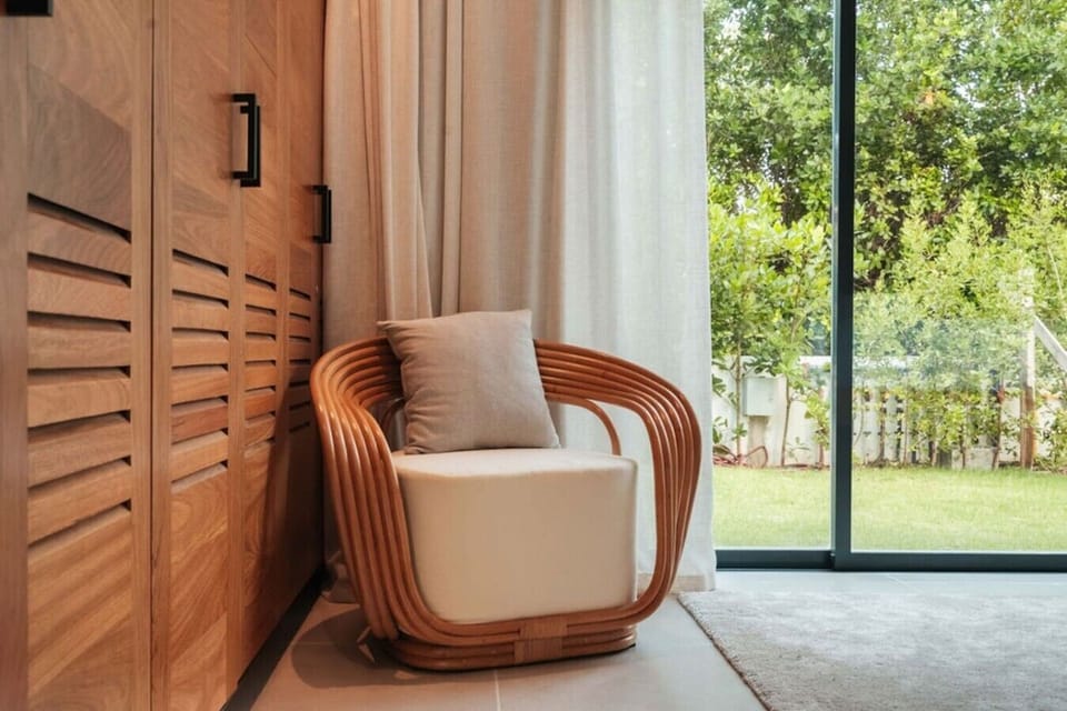 A cozy reading corner with a comfortable armchair and spacious built-in wardrobe.