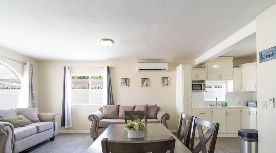 Alternate view of the gourmet kitchen highlighting custom cabinetry, granite countertops, and fully stocked appliances — toaster, coffee maker, and blender included .