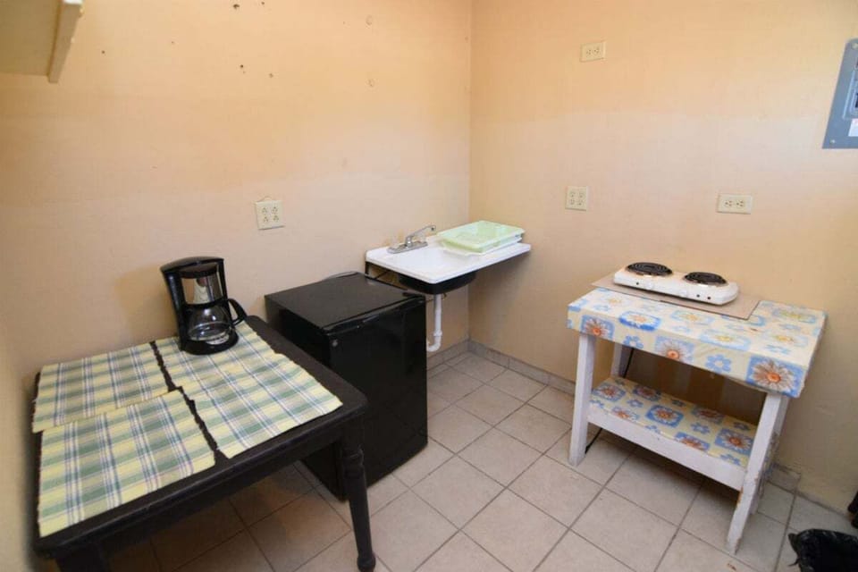The well-equipped kitchen includes a refrigerator, microwave, and essential cookware — plus a coffee maker and kitchen utensils for home-cooked meals