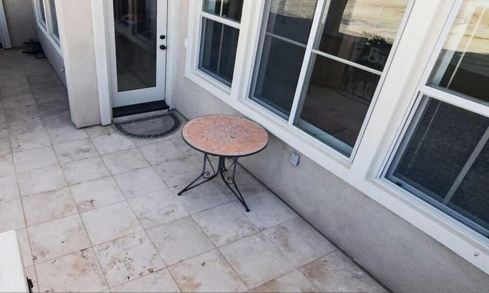 The front patio of this two-story vacation rental offers a quiet outdoor seating area overlooking the Las Caras de Mexico golf course — just steps from the community pool and private beach access.