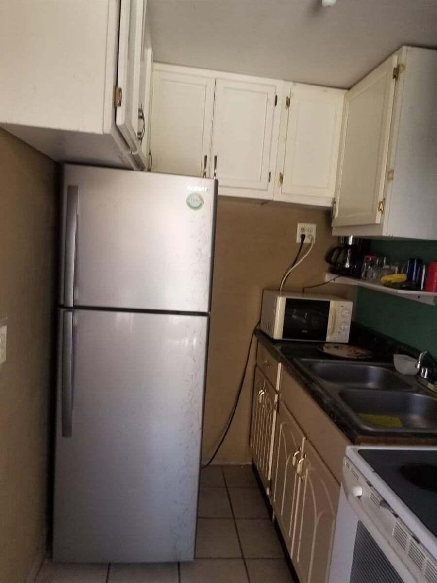 The full‑size refrigerator is located in the well‑appointed kitchen, alongside a microwave, coffee maker, and essential cookware.