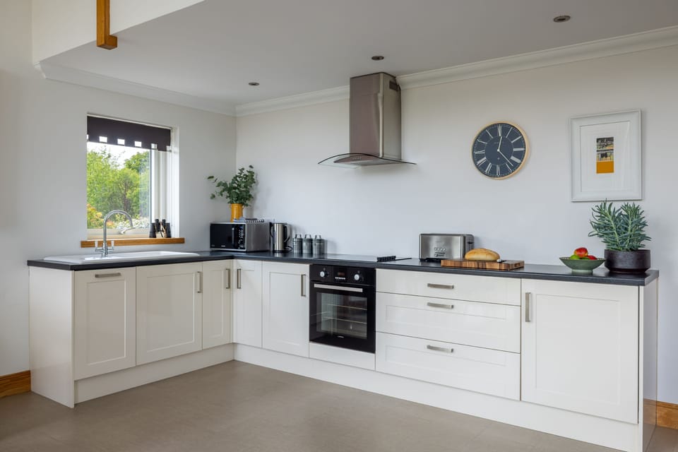 The kitchen - designed with simplicity and functionality in mind, the kitchen features modern cabinetry and plenty of space to cook and gather