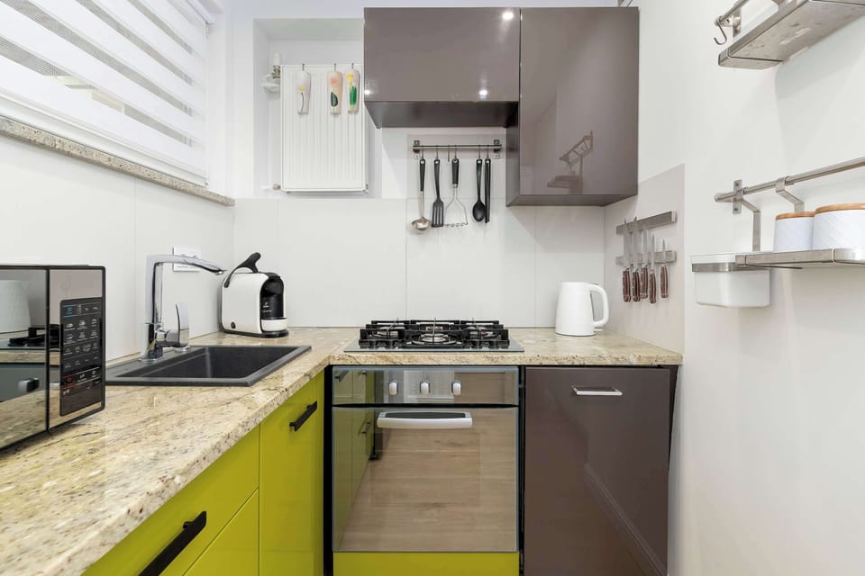 Another perspective of the kitchen showcasing practical workspace and storage solutions. The bright interior creates a pleasant atmosphere for cooking.