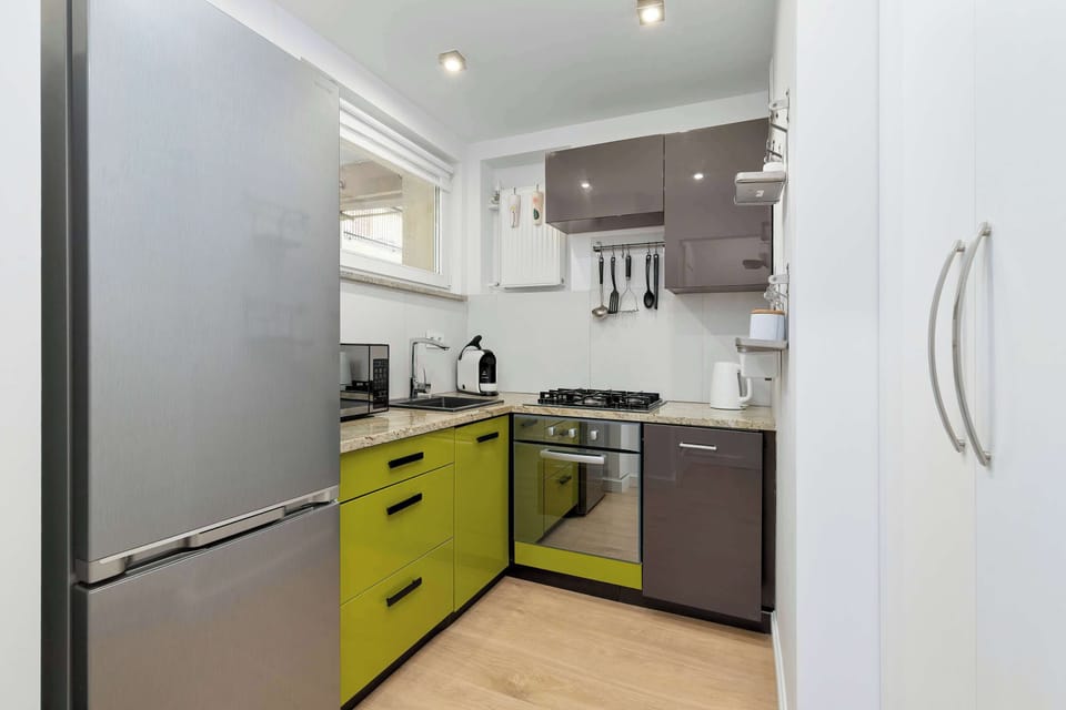 A modern refrigerator and kitchen area with sleek finishes and contemporary appliances. The space is designed to provide comfort and everyday convenience.