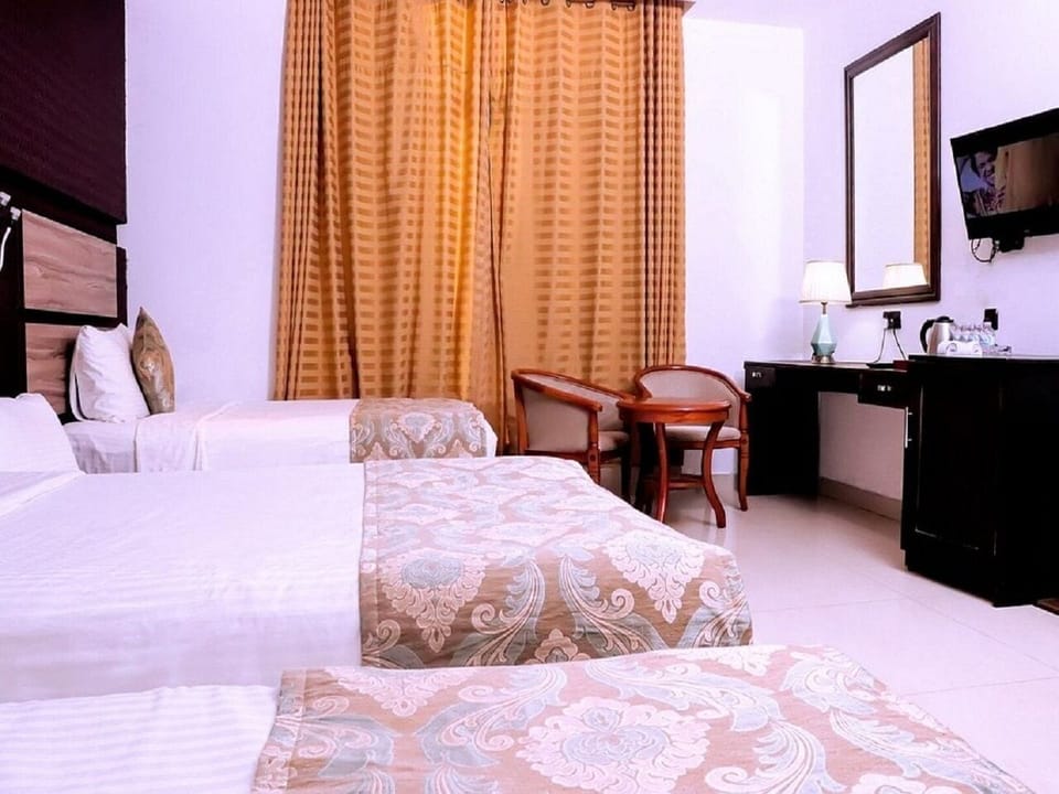 Deluxe Triple Room, Balcony, Garden View | Laptop workspace, free WiFi
