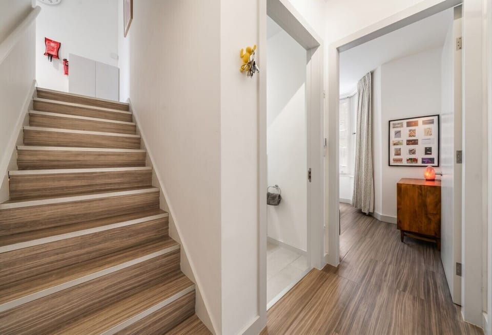 Light staircase connecting both floors reveals the layout of this two-floor flat.