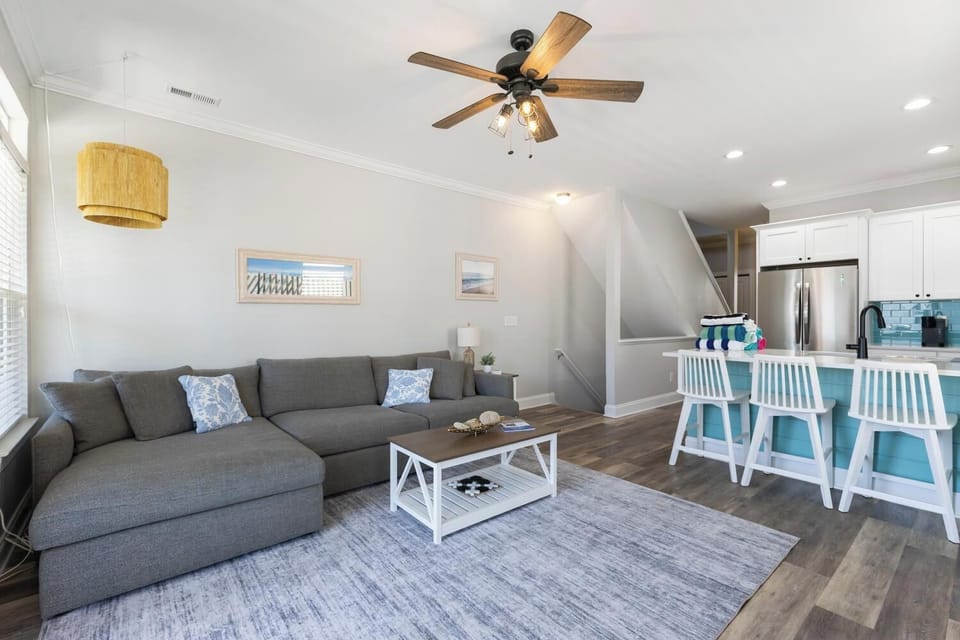 Unwind in your bright, coastal-inspired living space with plush seating and an open layout perfect for relaxing or gathering with your group after a day of beach adventures.