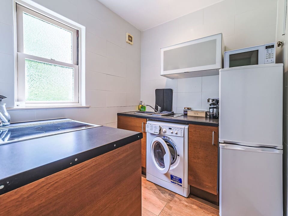 Washing Machine, Major Appliance, Flooring, Floor, Interior Design, Kitchen Appliance, Clothes Dryer, Room, Home Appliance, Kitchen