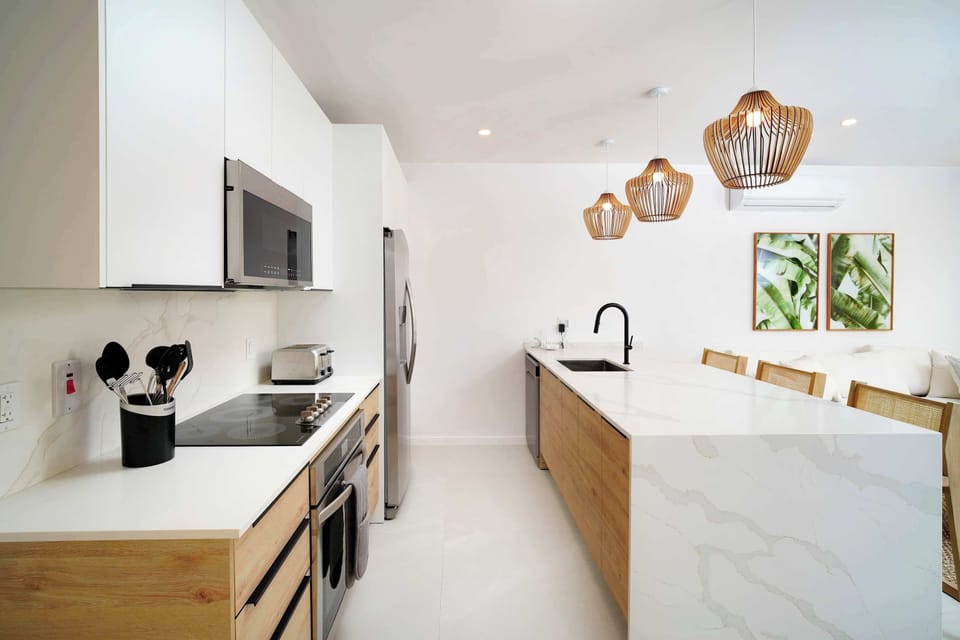 Kitchen: Open-concept living area with modern Caribbean flair, perfect for gatherings