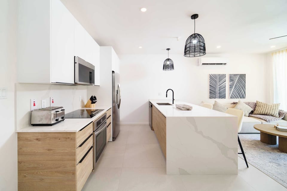 Kitchen: Open-concept living area with modern Caribbean flair, perfect for gatherings