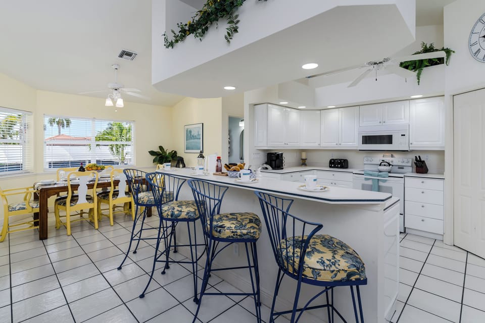 Your bright, open kitchen welcomes you with a spacious island, ample counter space for meal prep, and a cheerful dining area bathed in natural light.