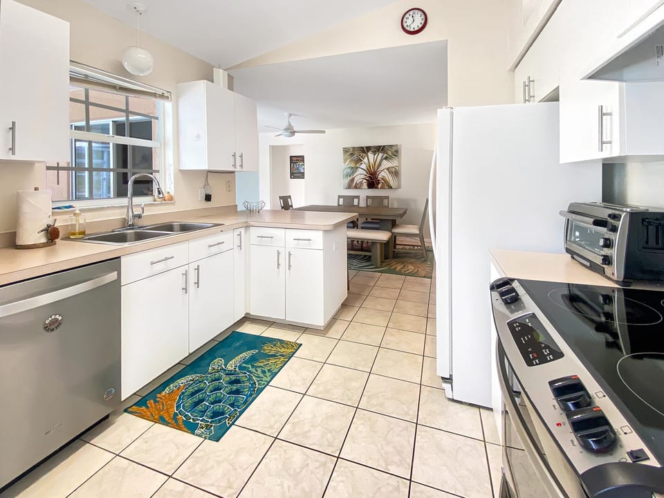 Modern kitchen with stainless steel appliances and cozy dining nook.