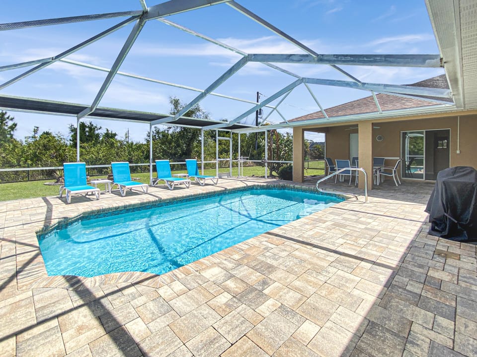 Relax by the private screened pool with ample seating and sunny views.
