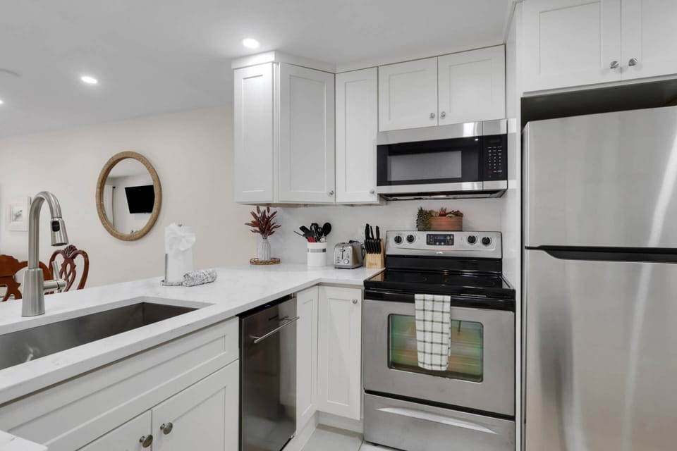The newly remodeled kitchen features quartz counters, a farmhouse sink and full appliance package.
