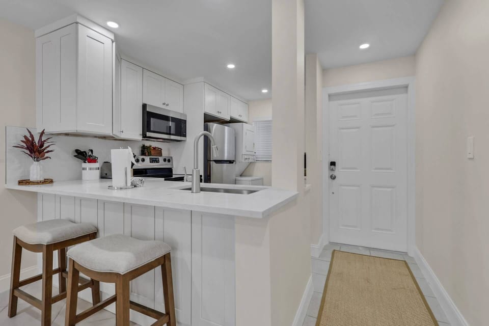 Additional seating for two is at the kitchen eating bar.