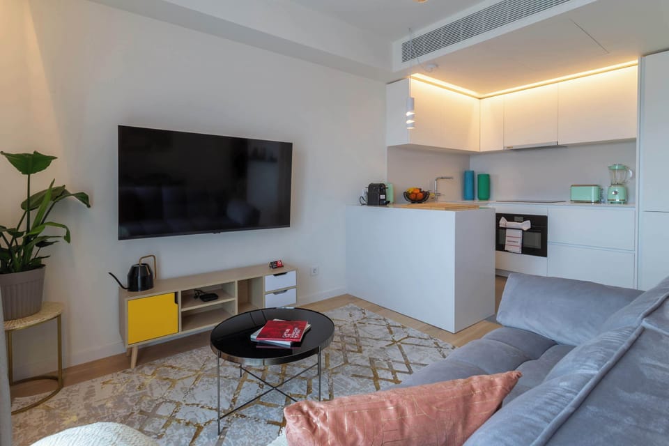 4 · Bright open-plan living and kitchen with city outlook · StayInLisbon