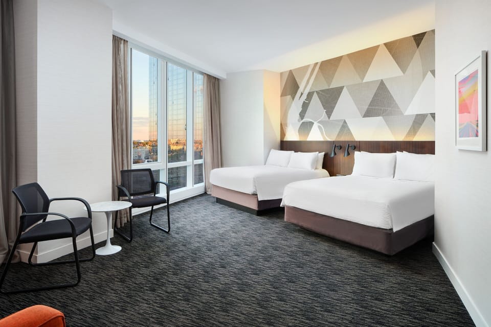 Family Room, 2 Queen Beds, Corner | In-room safe, desk, iron/ironing board, free cribs/infant beds