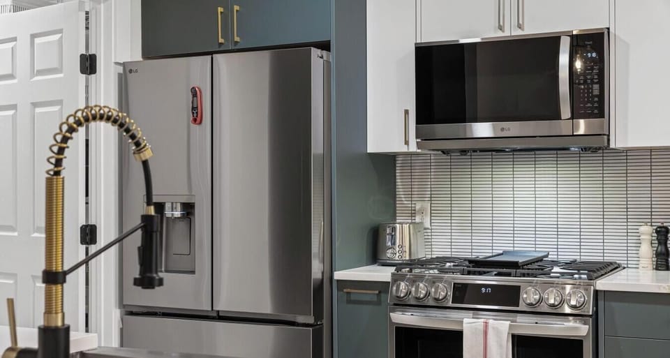 High-end stainless appliances include a gas range, French door fridge with ice maker, and over-range microwave.