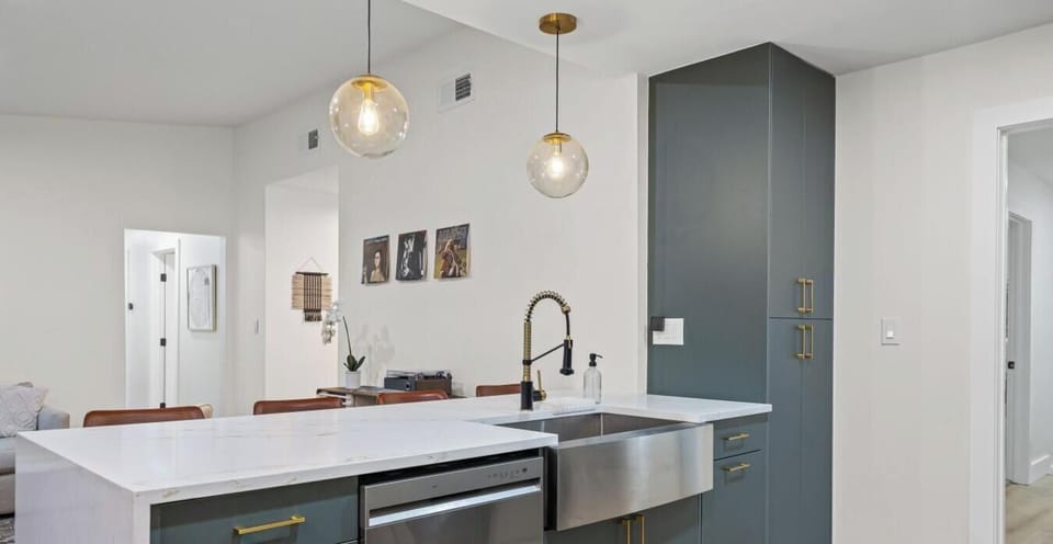 With plenty of prep space, bar seating, and a striking sink setup, this kitchen is built for both cooking and gathering.