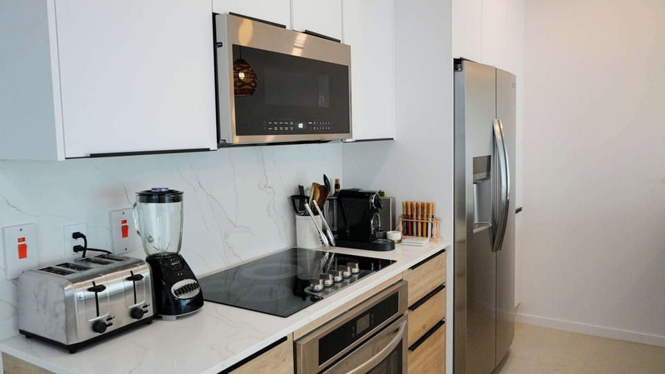Kitchen: Open-concept living area with modern Caribbean flair, perfect for gatherings