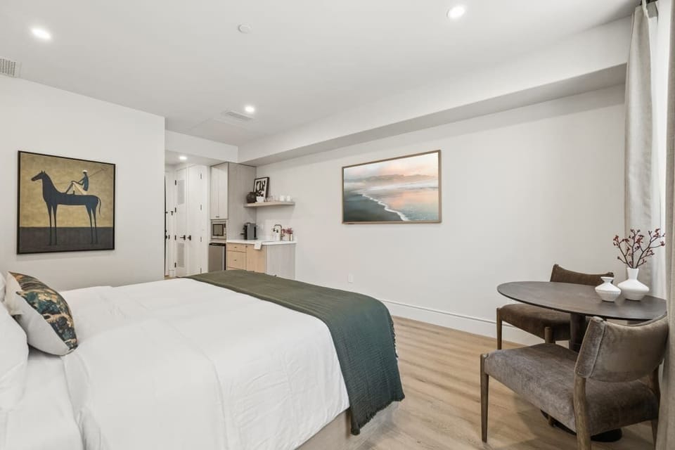 King-size bed, sleeps 2, seating area, and 65" Hisense TV 