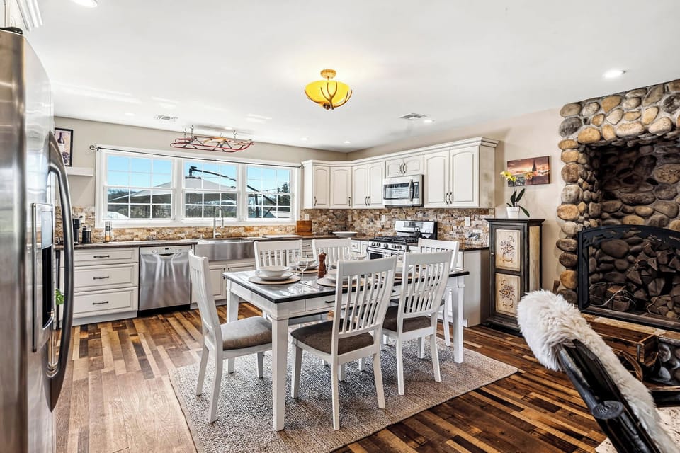 Dining area for six adjacent to kitchen and fireplace