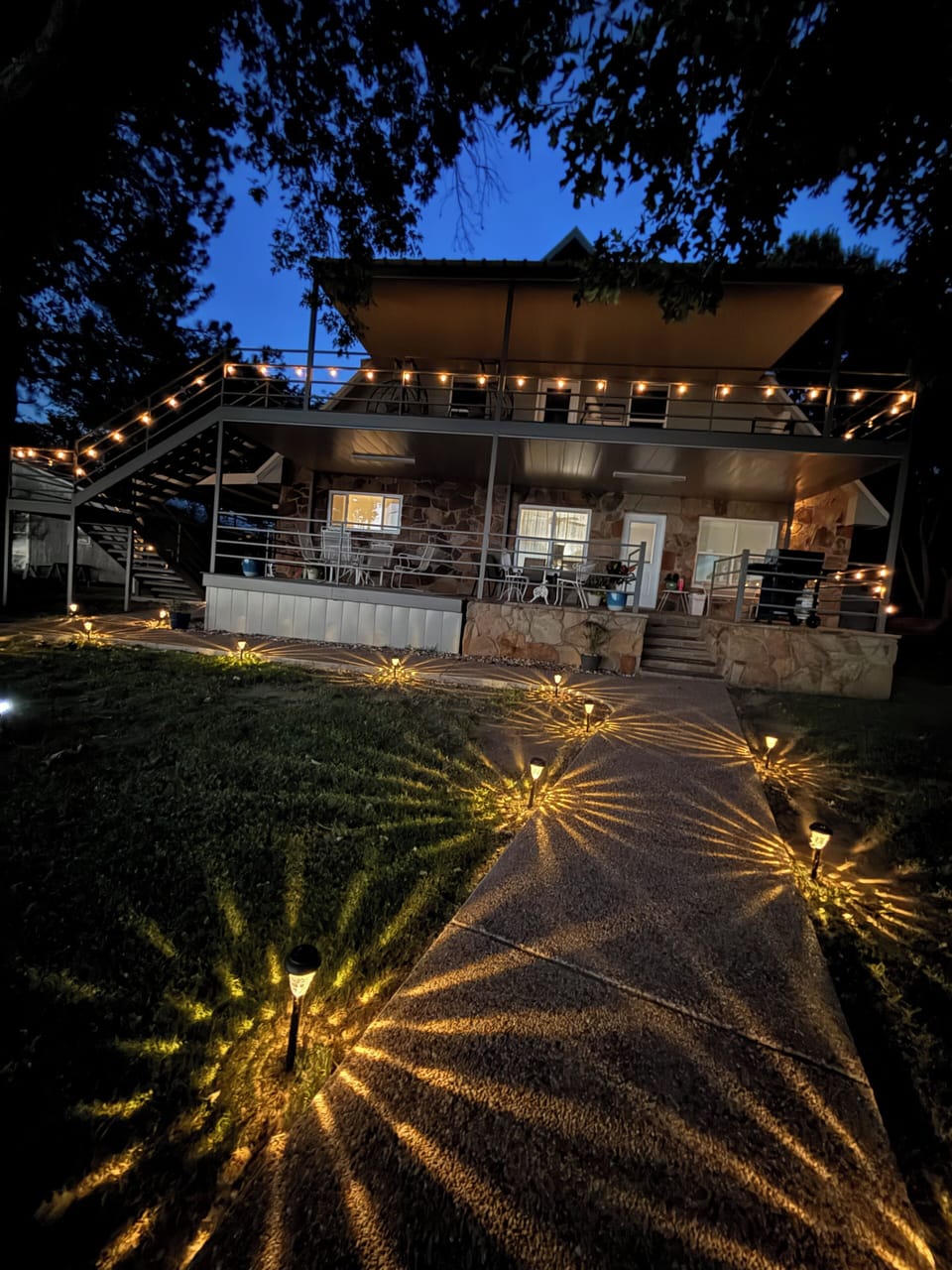 Solar lights illuminate the cozy lake side decks and pathways at night. 