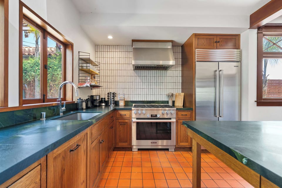 Kitchen — Miele 6-Burner Stainless Range, Stainless Hood, White Grid Tile Backsplash, Dark Green Soapstone Counters, Undermount Sink, Wire Open Shelving with Coffee Station & Craftsman Garden-View Windows