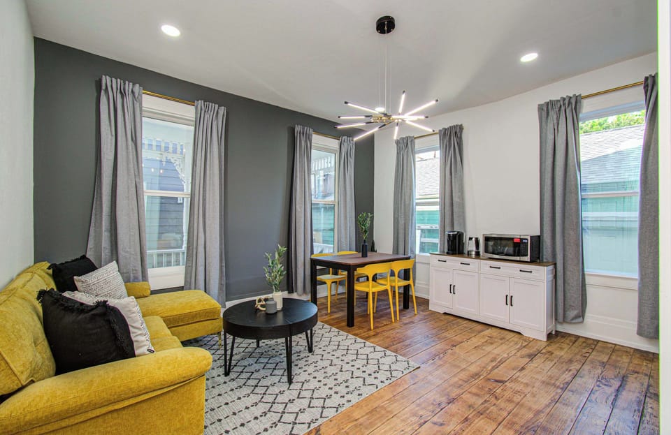Stylish lounge space with bold design, cozy seating, and café-style dining—perfect for relaxing or remote work.