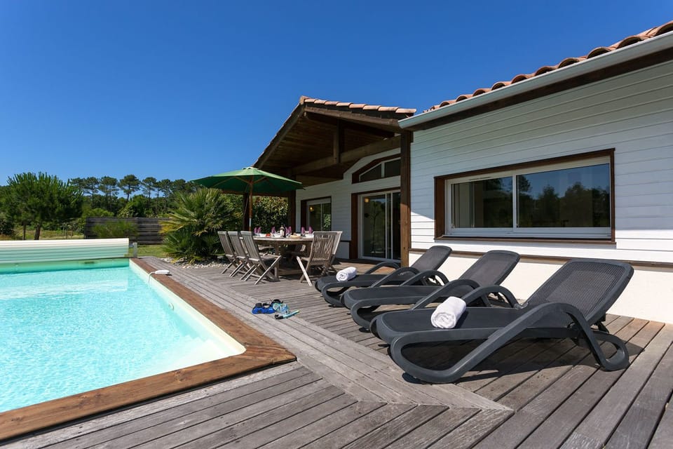 The garden opens directly onto the forest — walk the pine trails or stay poolside, the choice is yours.