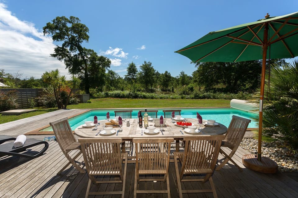 Outdoor table and chairs on the terrace — the garden is large enough to let everyone spread out.