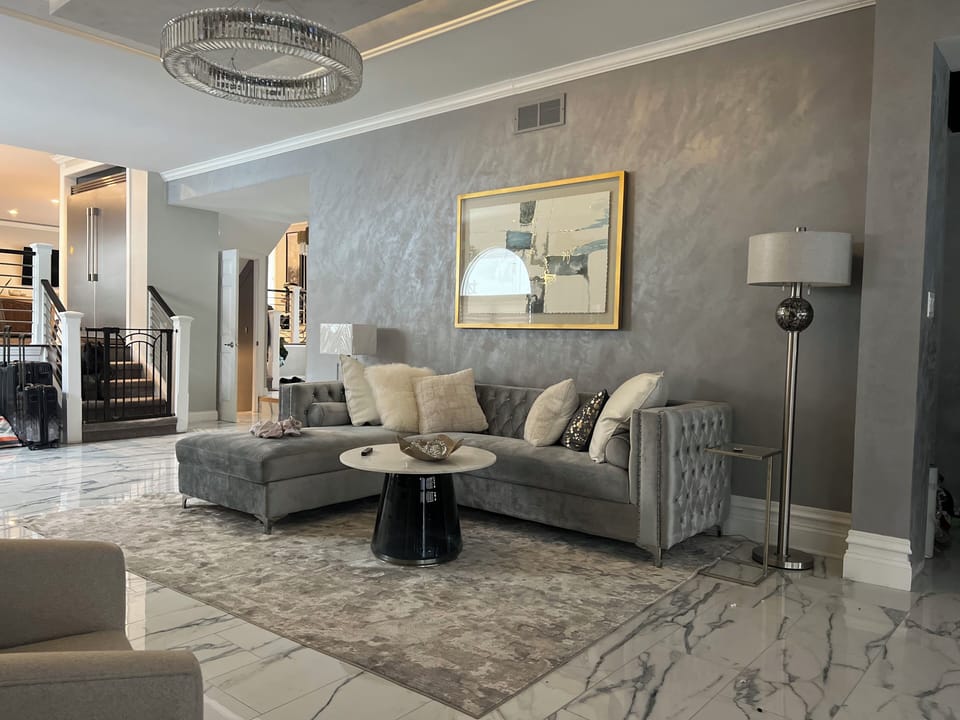 Formal living room on main floor, with electric fireplace.
